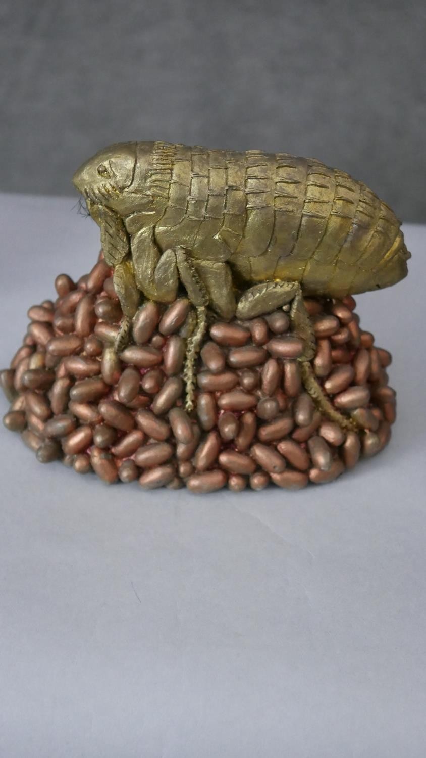 A gilded resin model of a flea on a pile of eggs along with a silvered covered model of a blue tit - Image 8 of 8