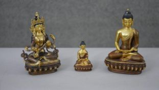 Three 20th century gilded copper Buddhist figures. One of Manjushri and the other two of Buddha.