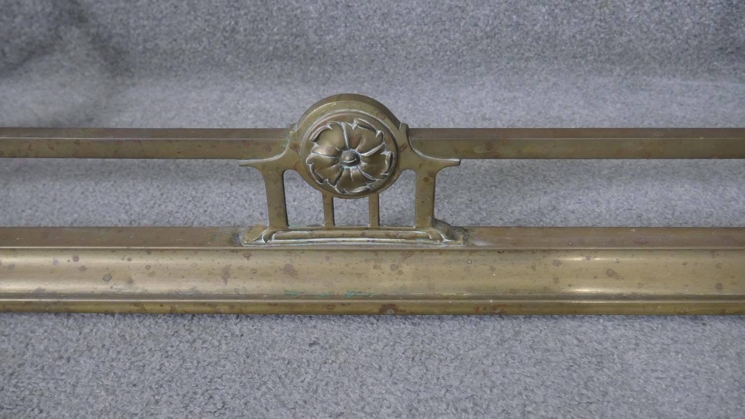 A 19th century brass fire kerb with flowerhead roundel decoration. H.25 W.138 D.40 cm - Image 5 of 5