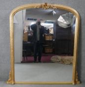 A 19th century style giltwood and gesso overmantel mirror with floral cresting and beaded frame. H.