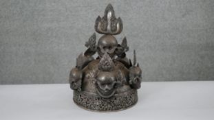 An early 20th century steel Tibetan oracle skull crown with flame motifs. Worn to ward away evil