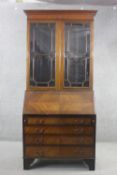 An Edwardian mahogany bureau bookcase with astragal glazed upper section above quarter veneered fall