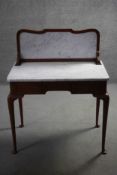 A C.1900 mahogany washstand with marble back and top on slender cabriole pad foot supports. H.104