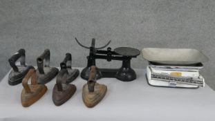 A collection of six irons and two sets of shop scales, one by Royal. H.13 W.28 D.17cm (largest)