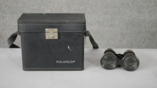 A vintage polaroid camera with case and accessories and pair of Victorian binoculars by Millikin &