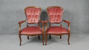 A pair of Continental style armchairs in buttoned velour upholstery on cabriole supports.