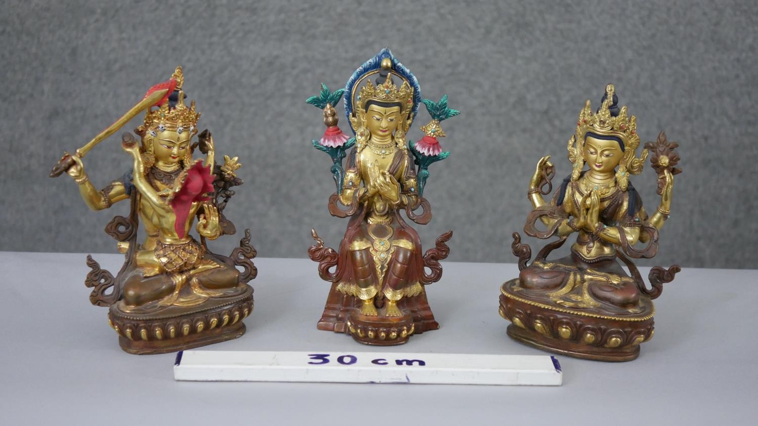 Three Tibetan gilded copper figures with hand painted detail and inlaid with coral and turquoise. - Image 2 of 9