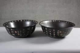 A pair of Chinese 20th century black glaze ceramic planters with incised narrative script design and