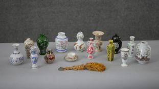 A collection of fourteen miniature replica Oriental vases with transfer design along with a