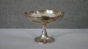 A silver floral design pedestal bowl. Hallmarked: Adie Brothers Ltd, Birmingham,1922. H.14 Diam.