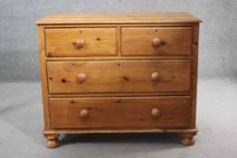 A Victorian pine chest of drawers on bun feet. H.87 W.105 D.56 cm.