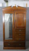 A 19th century walnut compactum wardrobe with bevelled mirrored door fitted with hanging space,