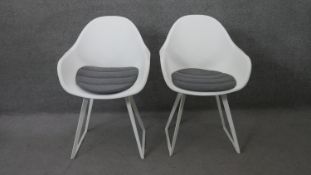 A pair of contemporary Eames style tub chairs by Made.com