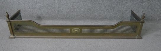 A 19th century pierced brass fire kerb with urn finials. H.28 W.130 D.34 cm