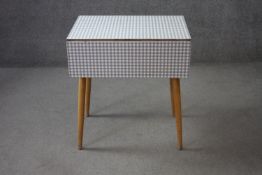 A mid century vintage drop flap kitchen table with gingham check laminated top. H.74 W.89 D.68 cm.
