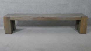 A planked top bench on block supports. H.45 W.204 D.41 cm