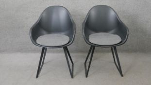A pair of contemporary Eames style tub chairs by Made.com