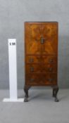 A mid century burr walnut tallboy cabinet on shell carved cabriole supports. H.124 W.51 D.26 cm