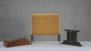 A mid century rattan magazine rack along with a teak and brass display stand and carved Nepalese