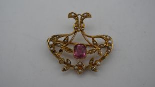 A Victorian yellow metal (tested 15 carat) seed pearl and pink stone brooch/pendant. Set with thirty
