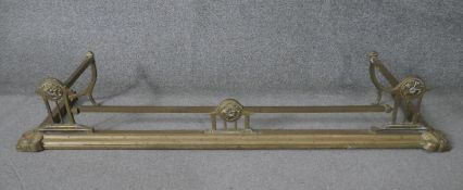 A 19th century brass fire kerb with flowerhead roundel decoration. H.25 W.138 D.40 cm