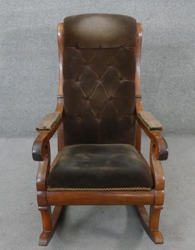 A 19th century mahogany framed rocking chair in buttoned velour upholstery.