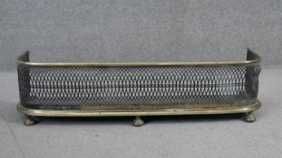 A 19th century pierced brass fire fender. H.23 W.87 D.24cm
