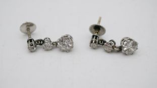 A pair of antique white metal (tested platinum) old cut diamond articulated drop earrings. Each
