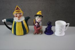 A Melba ceramic figure of Punch and his dog along with a moulded Bristol blue glass figure of