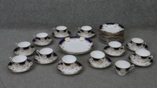 A Crown Staffordshire fine china royal blue and gold twelve person hand painted part tea set.