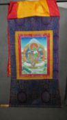 An early C20th Tibetan Thanka of green Tara. Full silk brocade surround and hanging pole. H.120 W.63