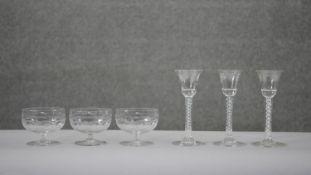 A collection of glasses. Including three Georgian air twist stem wine glasses with etched vine