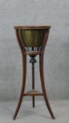 A 19th century mahogany jardiniere stand with brass liner on swept supports. H.90 Diam.37 cm (