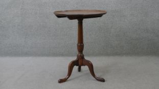 A Georgian mahogany dished and tilt top occasional table on baluster turned tripod cabriole base.