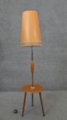 A mid century vintage standard lamp with laminated central tier on tripod dansette supports. H.147