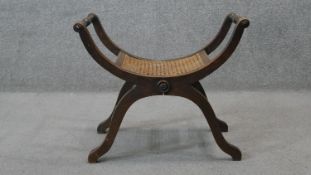 A 19th century X framed stool with caned seat. H.50 W.62 D.35 cm