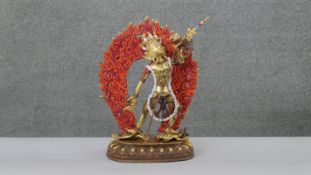 A large 20th century hand painted and gilded copper Vajrayogini figure with hand painted detail