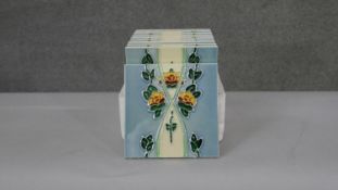 A collection of ten Art Nouveau style tube lined floral design ceramic tiles. H.15 W.15cm
