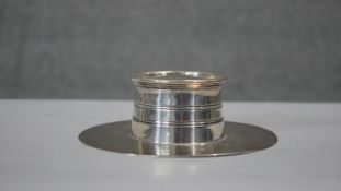 A Victorian circular silver lidded inkwell and quill holder. Inkwell has original glass liner.