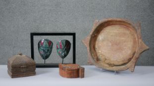 A collection of carved hardwood items. Including a pair of painted African masks, a carved tribal