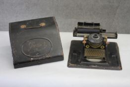 A vintage tin plate Junior type writer with case. H.14 W.22 D.22cm.