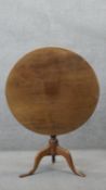 A Georgian mahogany tilt top occasional table on baluster turned pedestal and tripod cabriole pad