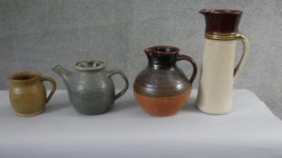 A collection of studio pottery. Including a brown glaze terracotta jug, a stoneware water jug and