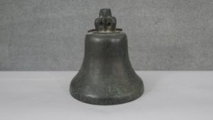 An early 20th century bronze bell, inscribed to the rim 20 3/4. H.25 Diam.24cm