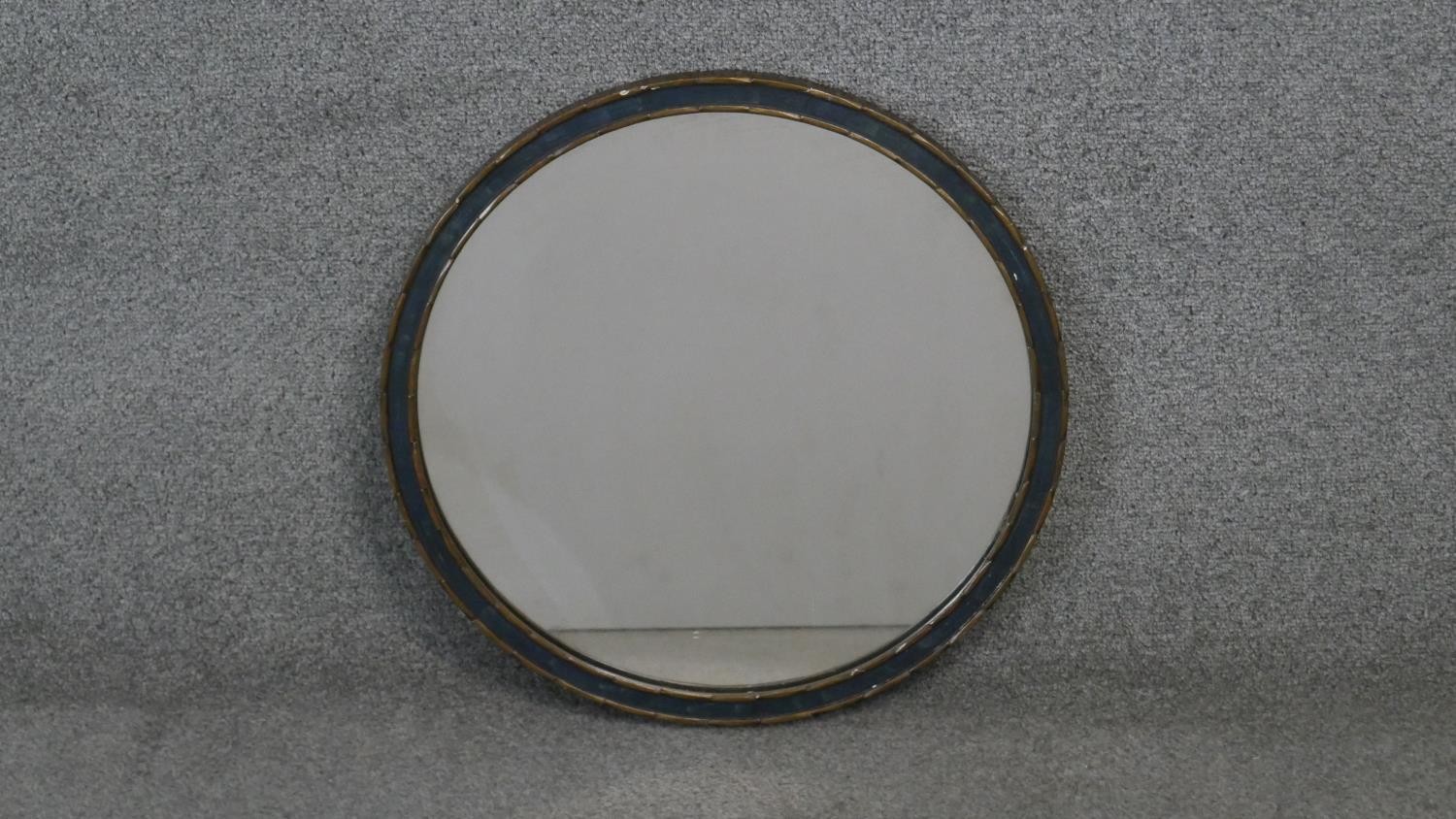An early 20th century giltwood circular mirror with hanging chain. Diam.46 cm