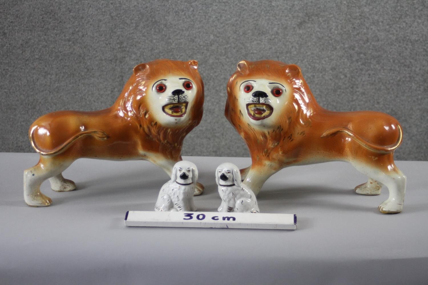 A pair of 19th century Staffordshire pottery lions with glass eyes along with a pair of - Image 2 of 8