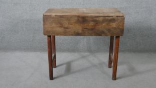 A 19th century pine drop flap kitchen table. H.66 W.84 D.83 cm