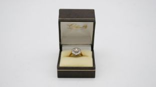 A 18 carat gold and white metal (tested platinum) diamond cluster ring. Set with seven round
