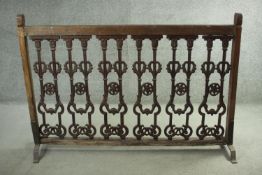 A wrought iron balustrade section in hardwood frame mounted on platform feet. H.110 W.162 cm.