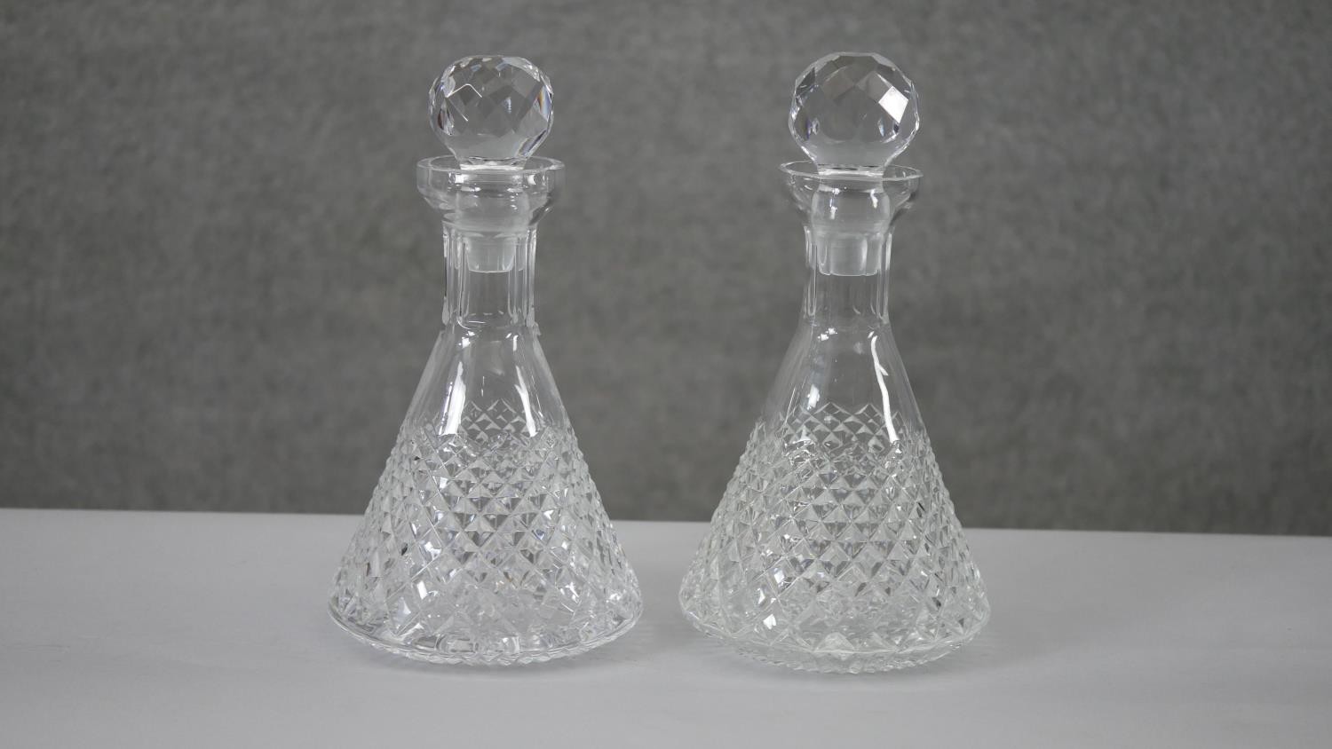 A pair of Tyrone cut crystal conical design decanters with ball stoppers. Stamped to the base. H.